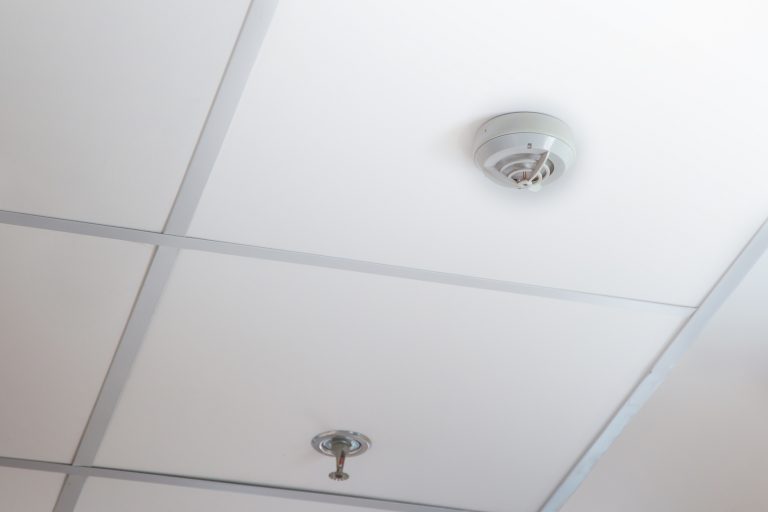 Smoke detector and pendent fire sprinkler on a ceiling,fire emergency